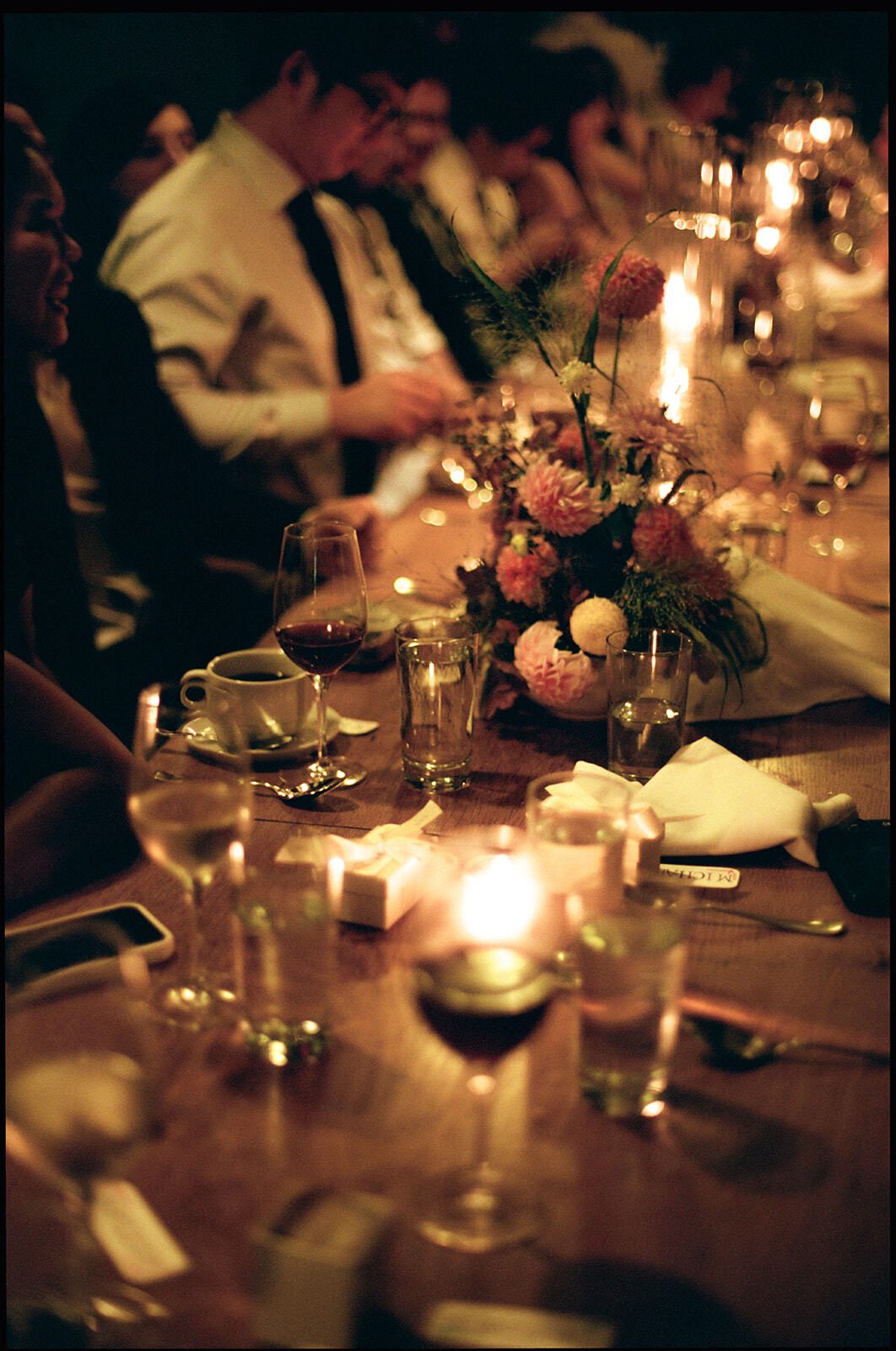 Candlelit wedding dinner with florals, wine glasses and guests in black tie, Adena and Brian's wedding, by Brooklyn wedding photographer Lana Dubkova on film.